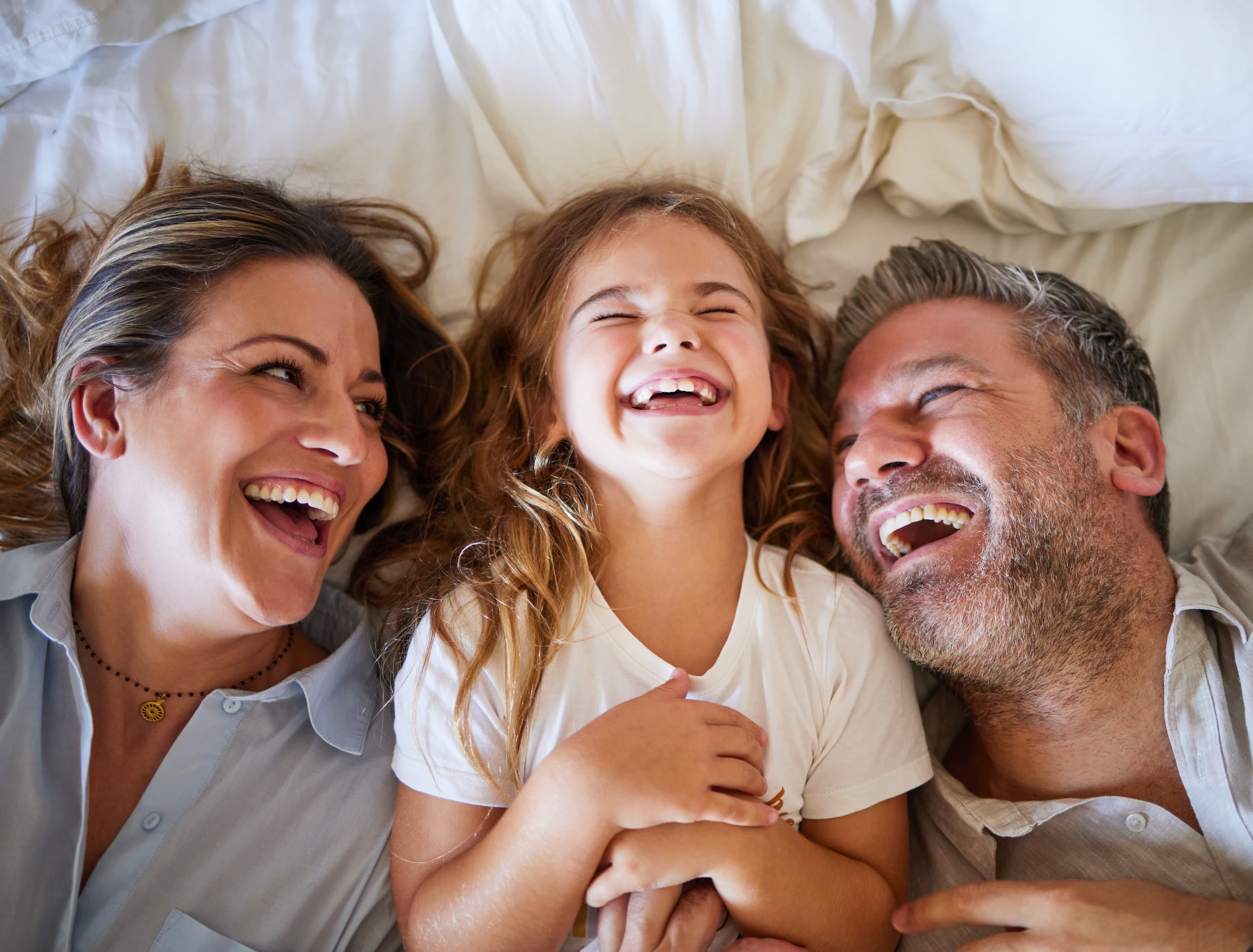 Happy smiling family laughing together, family dental care at Schonsee Dental in Edmonton