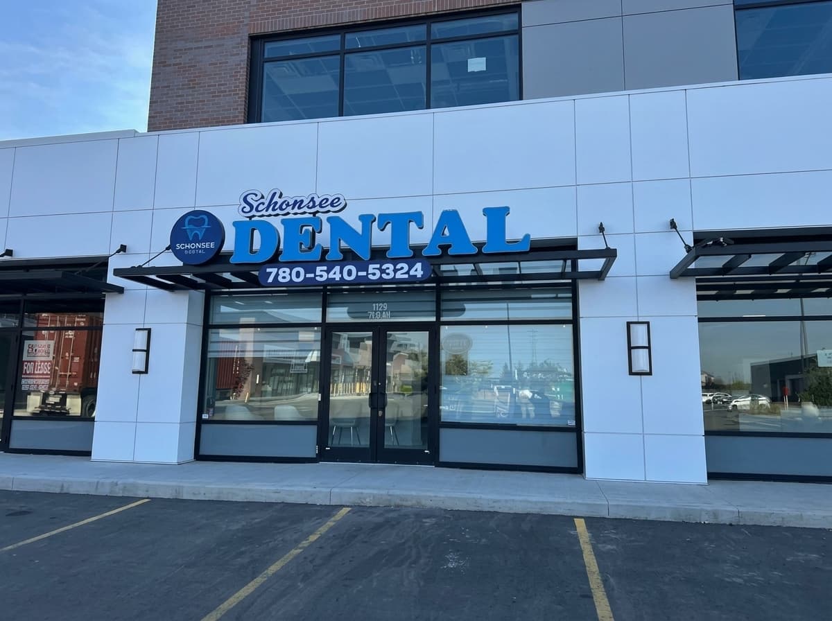 A smiling dental professional with a relaxed patient in a bright, modern treatment room at Schonsee Dental in Edmonton